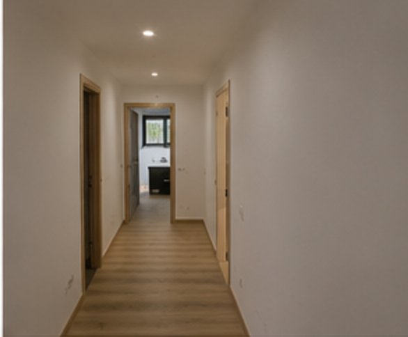 Pasillo de vivienda terminado con suelo laminado